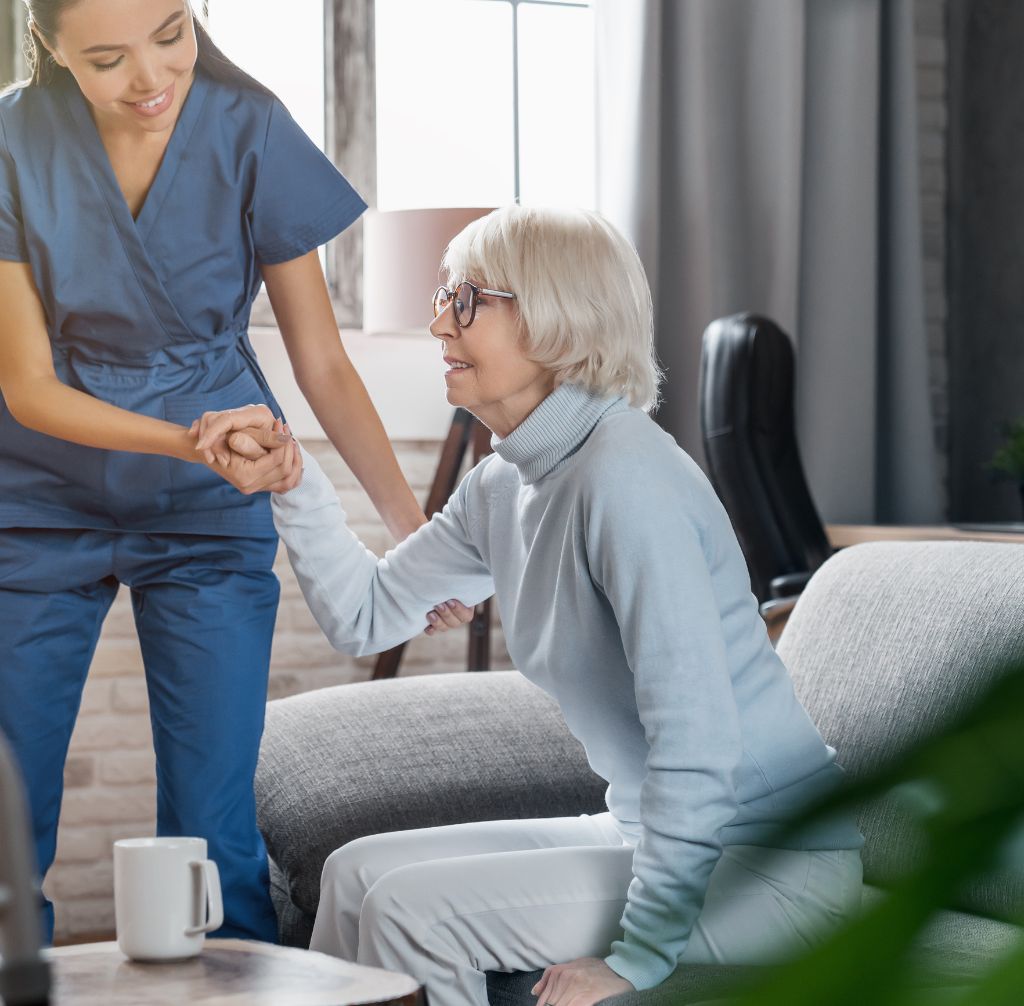 Carer taking care of elderly woman at home