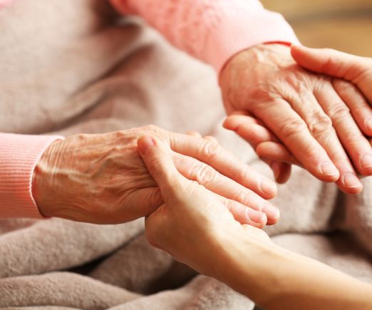 Young Person Holding an Elderly Woman's Hands